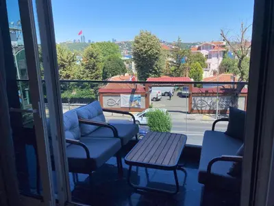 a balcony with chairs and a table and a view at Mateo in Istanbul
