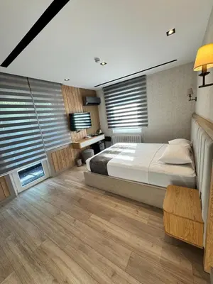 a bedroom with a large bed and some windows at Mateo in Istanbul