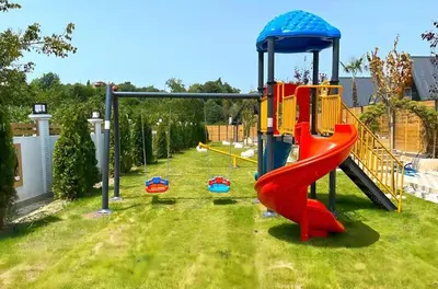 a playground with a slide in the grass at 7Sense Nature Resort in Sapanca