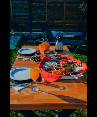 a table with a tray of food and glasses of orange juice at 7Sense Nature Resort in Sapanca