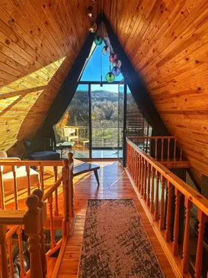 an attic room with a staircase and a large window at 7Sense Nature Resort in Sapanca