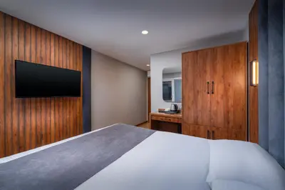 a bedroom with a bed and a flat screen tv at Elite Port Hotel Istanbul Airport in Arnavutköy