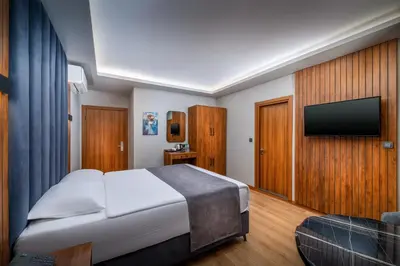 a hotel room with a bed and a flat screen tv at Elite Port Hotel Istanbul Airport in Arnavutköy