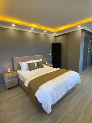 a large bedroom with a large bed with white sheets at Sahra Kent Otel Kadıköy in Istanbul