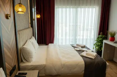 a bedroom with a white bed with a window at Linda Port Hotel in Istanbul
