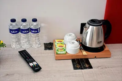 a table with a coffee maker and two bottles of water at Linda Port Hotel in Istanbul
