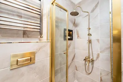 a bathroom with a shower with a glass door at Begonville Corner in Istanbul