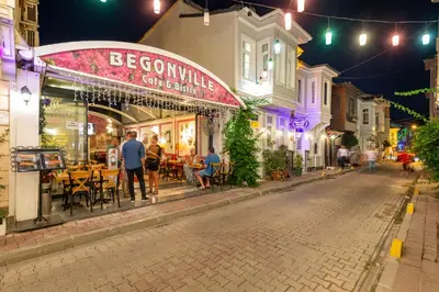 a group of people standing outside a restaurant at night at Begonville Corner in Istanbul