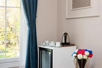 a room with a table with flowers and a window at Begonville Corner in Istanbul