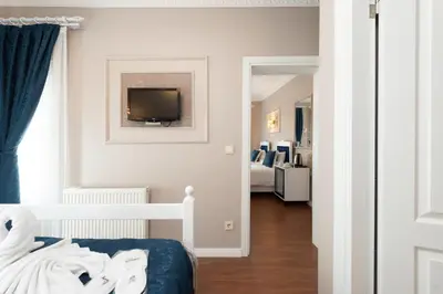 a bedroom with a bed and a tv on the wall at Begonville Corner in Istanbul