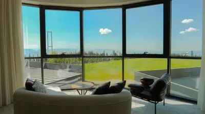 a living room with a couch and chairs and a large window at Motel Heksapolis in Tavşancıl