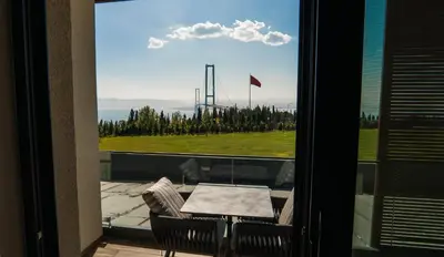a balcony with a table and a view of a field at Motel Heksapolis in Tavşancıl