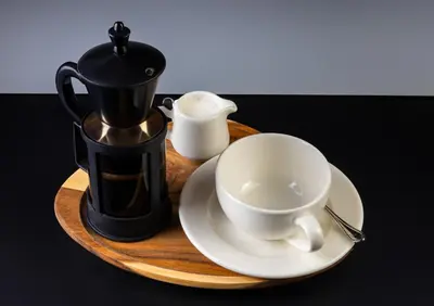 a coffee pot and a cup on a wooden tray at Motel Heksapolis in Tavşancıl