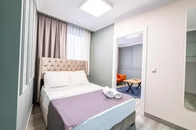 a small bedroom with a bed and a window at The Royal Luxury Hotels in Istanbul