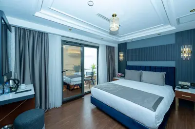 a bedroom with a king sized bed and a balcony at Freya Hotel in Istanbul