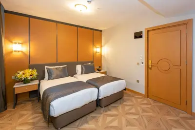 a hotel room with two beds and a door at Freya Hotel in Istanbul
