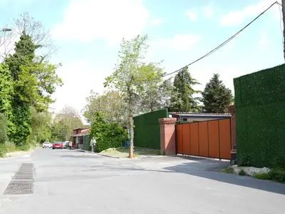 a street with a fence and a house with a driveway at Mia Mia Suites in Istanbul