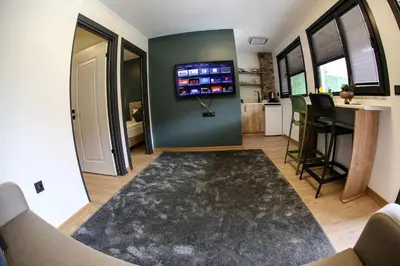 a living room with a tv on the wall at Mia Mia Suites in Istanbul