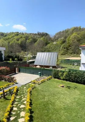 a garden with yellow flowers and a building at Sapanca Villa Dereiçi in Sapanca
