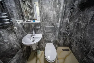 a bathroom with a toilet and a sink at Amida Family apart in Istanbul