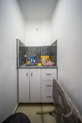 a small kitchen with white cabinets and a sink at Amida Family apart in Istanbul