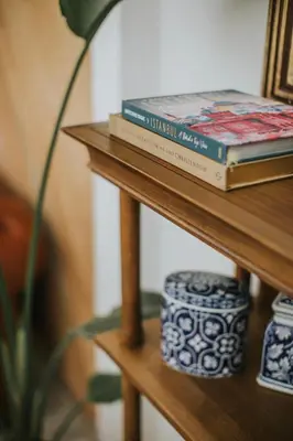 two books and a vase on a wooden shelf at Blu Macel Hotel & Suites -Old City Sultanahmet in Istanbul