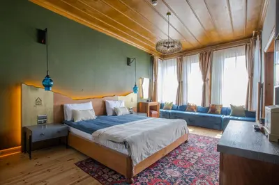 a bedroom with a large bed and a living room at Blu Macel Hotel & Suites -Old City Sultanahmet in Istanbul