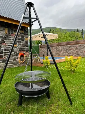 a swing in a yard with an umbrella at ROSE SAPANCA STONE HOUSE in Sakarya