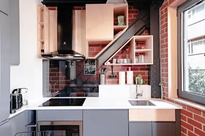 a kitchen with a sink and a brick wall at Homie Suites - ''Loft 27'' Urban Comfort Suites in the Heart of Cihangir in Istanbul