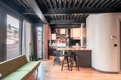 a kitchen and living room with a couch and a table at Homie Suites - ''Loft 27'' Urban Comfort Suites in the Heart of Cihangir in Istanbul