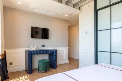 a bedroom with a fireplace and a tv on the wall at Khai Karaköy in Istanbul