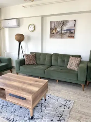 a living room with a green couch and a coffee table at King Suite SA2 in Esenyurt