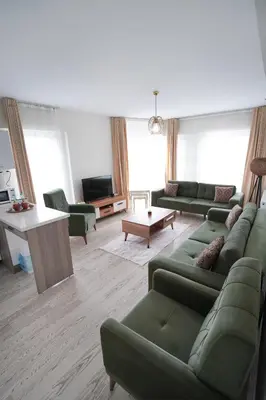 a living room with green couches and a table at King Suite SA2 in Esenyurt