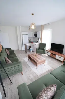 a living room with green couches and a coffee table at King Suite SA2 in Esenyurt