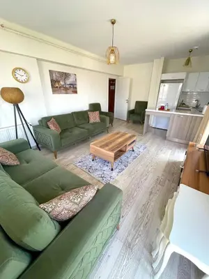 a living room with green couches and a coffee table at King Suite SA2 in Esenyurt