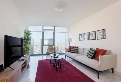 a living room with a couch and a flat screen tv at Gorgeous Corner Deluxe 1BD CondoPoolViews! #133 in Istanbul