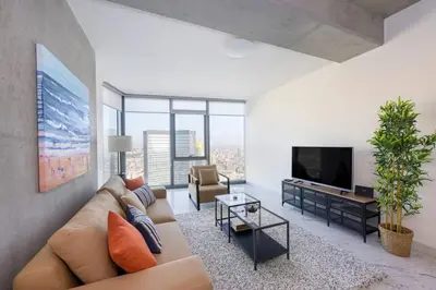 a living room with a couch and a tv at Bright Lovely Deluxe 1BD CondoPoolViews! #134 in Istanbul