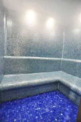 a blue tiled bathroom with a shower with blue tiles at Bright Lovely Deluxe 1BD CondoPoolViews! #134 in Istanbul