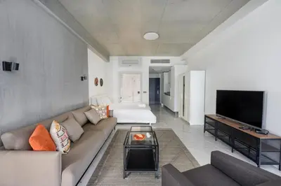a living room with a couch and a flat screen tv at Gorgeous Bright Studio Parking PoolViews! #135 in Istanbul