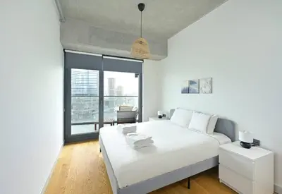 a bedroom with a white bed and a large window at Gorgeous Modern 1BD TerracePoolViews! #183 in Istanbul
