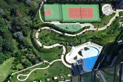 an overhead view of a tennis court and a pool at Gorgeous Modern 1BD TerracePoolViews! #183 in Istanbul