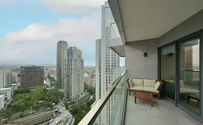 a balcony with a couch and a view of a city at Gorgeous Modern 1BD TerracePoolViews! #183 in Istanbul