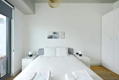 a white bedroom with a white bed and two night stands at Gorgeous Modern 1BD TerracePoolViews! #183 in Istanbul