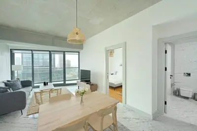 a living room with a table and a couch at Gorgeous Modern 1BD TerracePoolViews! #183 in Istanbul
