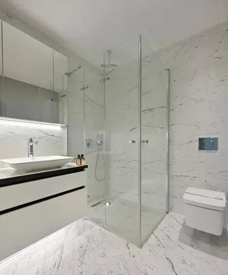 a bathroom with a shower and a toilet and a sink at Cool Airy Modern 2bd2bath Parkingpoolgym! #219 in Istanbul