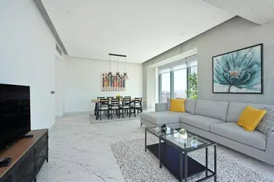 a living room with a couch and a table at Cool Airy Modern 2bd2bath Parkingpoolgym! #219 in Istanbul