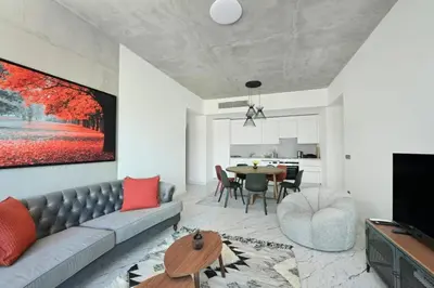 a living room with a couch and a table at Bright Lovely Modern 2BD25 Condo PoolGym! #220 in Istanbul