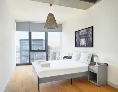a white bedroom with a bed and a large window at Beautiful Modern 1BD Condo Views w PoolGym! #223 in Istanbul