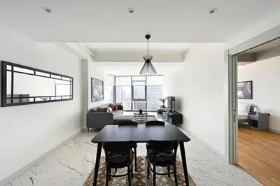 a living room with a table and a couch at Beautiful Modern 1BD Condo Views w PoolGym! #223 in Istanbul