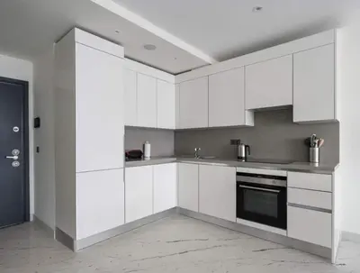 a white kitchen with white cabinets and a stove at Lovely Modern 1BD Condo Views w PoolGym! #222 in Istanbul